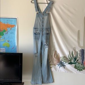 Distressed overalls with flared legs